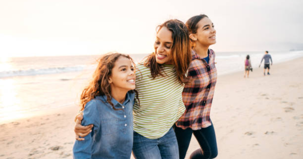 mom with her daughters on a beach